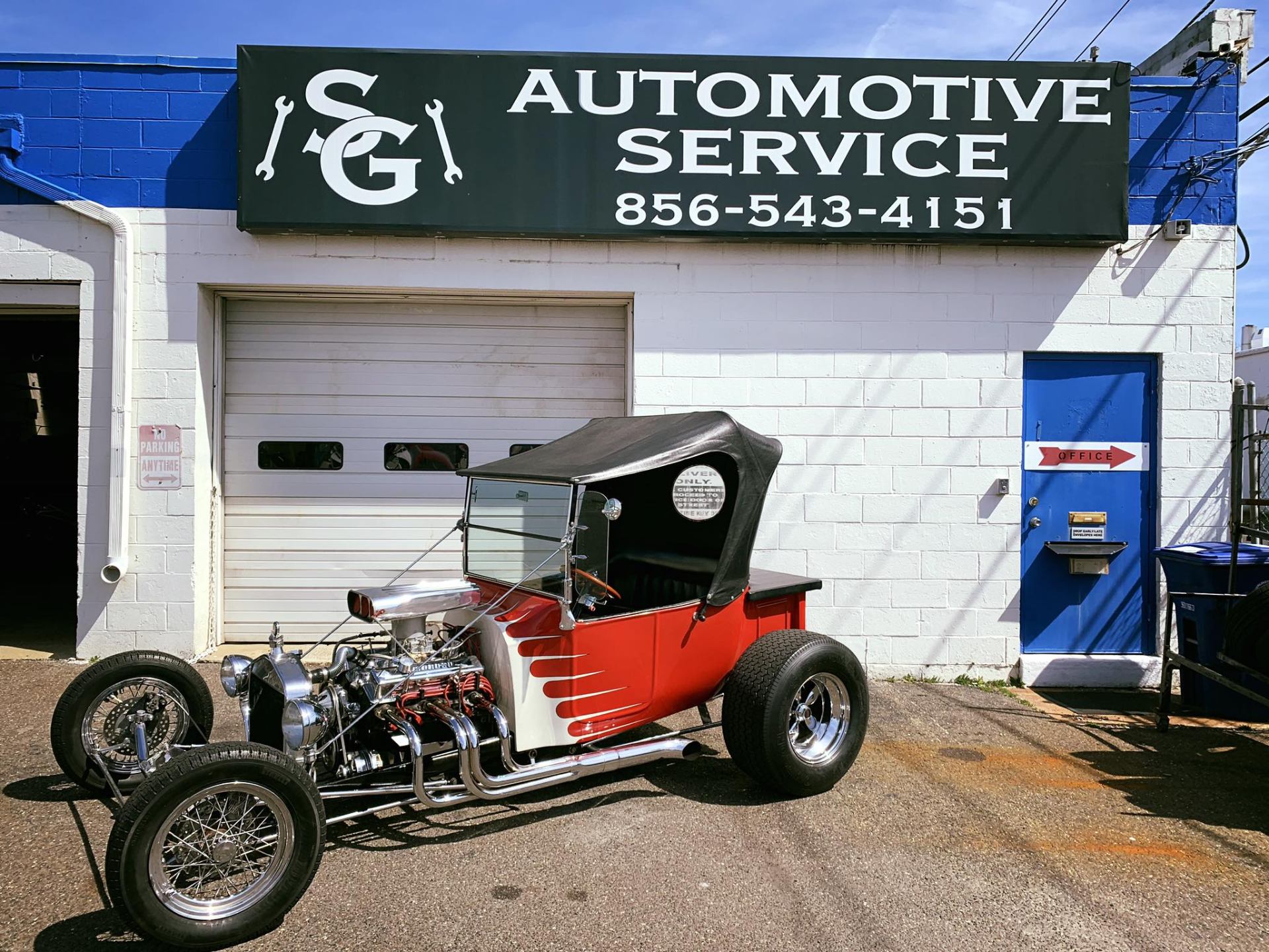 Classic red flame hot rod T-bucket parked at SG Automotive
