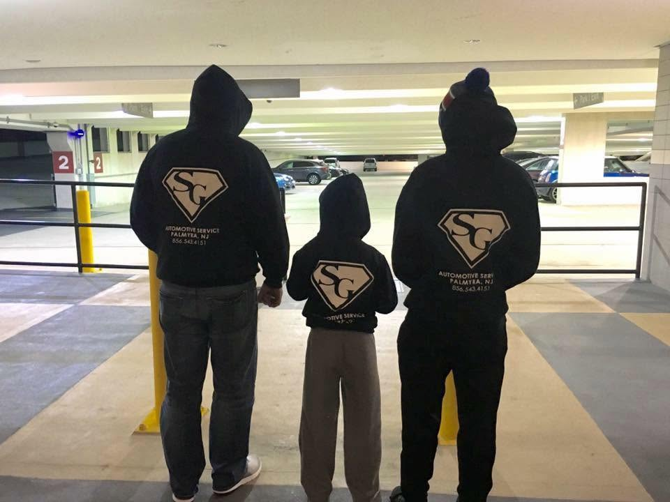 SG Automotive family wearing branded shop hoodies