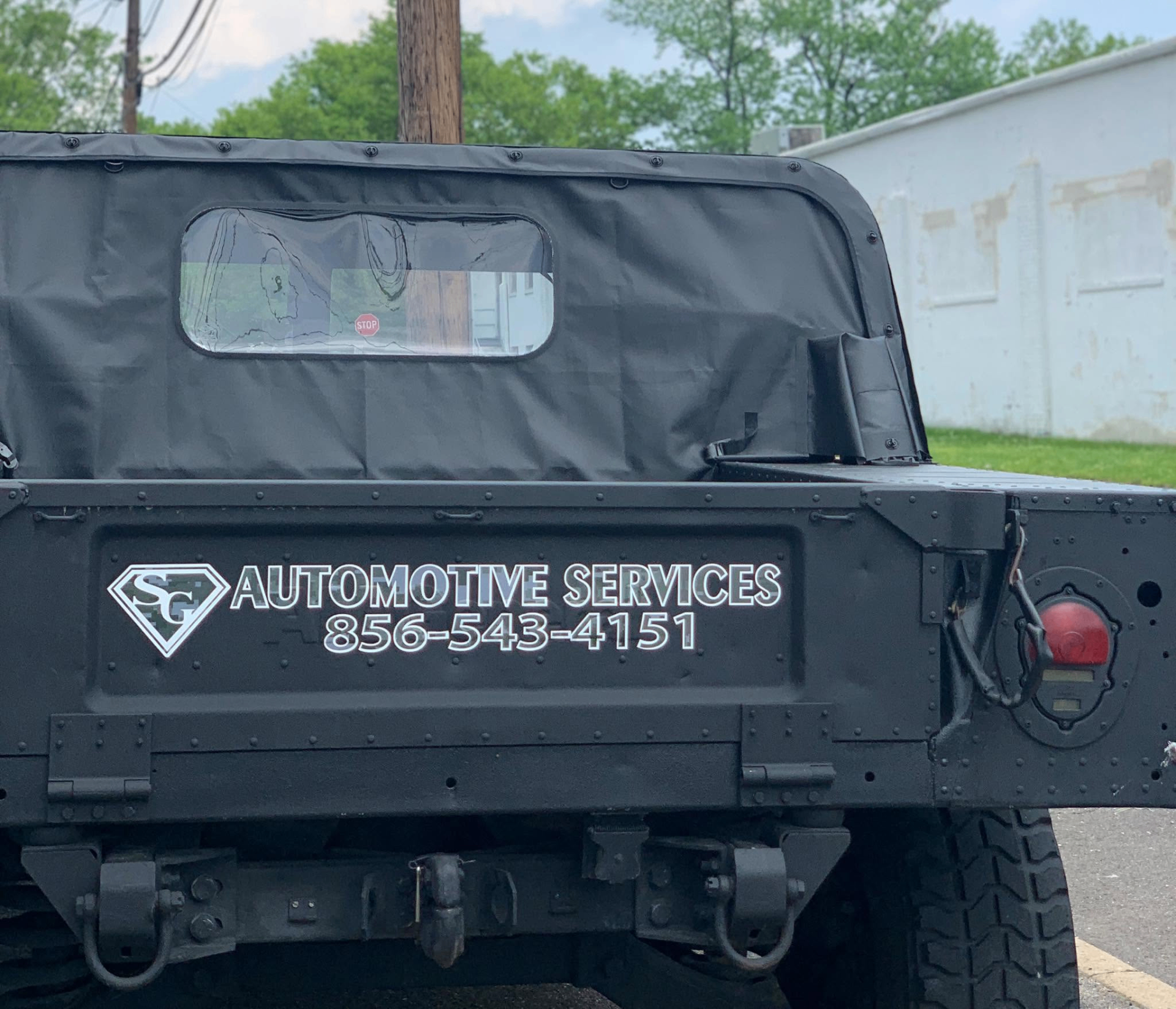 SG Automotive Services decal on a Humvee tailgate