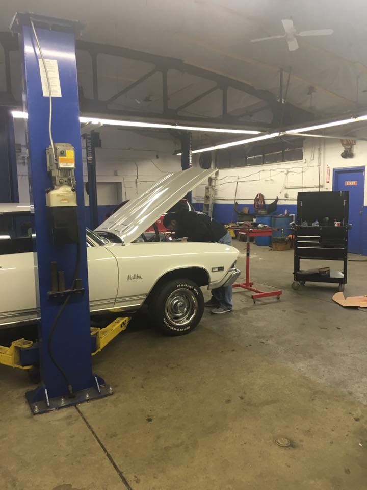 Classic Chevrolet Malibu on lift being serviced